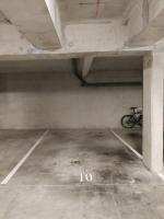 a bike parked in an empty parking garage at Appartement NATURA 2 chambres in Vitré