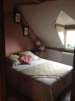 a bedroom with a bed in a attic at Gîtes du Manoir de la Porte in Les Authieux-sur-Calonne