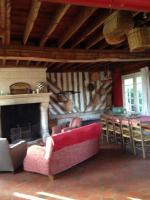 a living room with a couch and a fireplace at Gîtes du Manoir de la Porte in Les Authieux-sur-Calonne