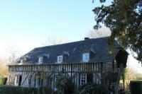 an old house with a gambrel roof on top of it at Gîtes du Manoir de la Porte in Les Authieux-sur-Calonne