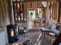 a living room with a wood stove in a room at Gîtes du Manoir de la Porte in Les Authieux-sur-Calonne