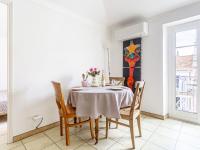 a dining room with a table and chairs at Apartment Foncet by Interhome in Nice