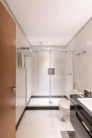 a white bathroom with a shower and a toilet at DELPLAZA Timbiras São Paulo in São Paulo