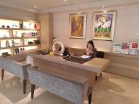 a woman sitting at a desk in a store at The Gaia Hotel - Taipei in Taipei