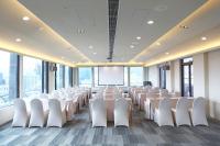 a conference room with white chairs and a projection screen at The Gaia Hotel - Taipei in Taipei