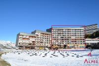 a large building in the snow next to a beach at Résidence Chaviere - Studio pour 2 Personnes 034 in Les Menuires