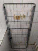a tiled shower with a metal rack in a bathroom at Confortable appart 5 mins centre de valenciennes in Anzin
