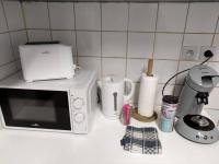 a kitchen counter with a microwave and a coffee maker at Confortable appart 5 mins centre de valenciennes in Anzin