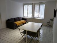 a living room with a couch and a table at Confortable appart 5 mins centre de valenciennes in Anzin