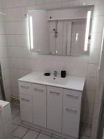 a white bathroom with a sink and a mirror at Confortable appart 5 mins centre de valenciennes in Anzin