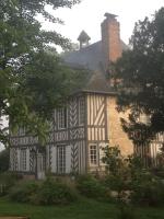 a large house with a chimney on top of it at Gîtes du Manoir de la Porte in Les Authieux-sur-Calonne