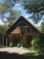 a small house with a gambrel roof at B&amp;B Au bois dormant chambres d hotes in Tillé