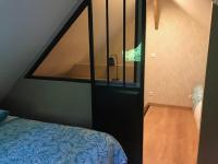 a small room with a bed and a stairway with at B&amp;B Au bois dormant chambres d hotes in Tillé