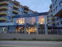 a building with a sign that reads odesleediaedia at Bianco Apartament Reduta Park Free Parking in Kraków