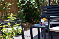 a black table with a glass of wine on it at Hampton By Hilton Toulouse Airport in Blagnac