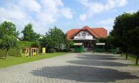 a house with a playground in front of a building at Vila Šiftar in Moravske Toplice