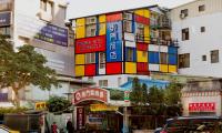 a building with colorful signs on the side of it at Dong Men Hotel in Taipei