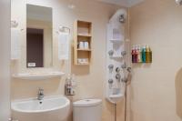 a bathroom with a sink and a toilet and a shower at Kindness Hotel - Tainan Minsheng in Tainan