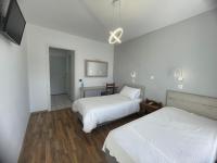 Postel nebo postele na pokoji v ubytování Hotel Anthousa
