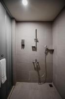 a bathroom with a shower with a hose on a wall at Hub Hotel Kaohsiung Yawan Branch in Kaohsiung