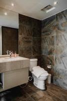 a bathroom with a toilet and a sink and a mirror at Hub Hotel Kaohsiung Yawan Branch in Kaohsiung