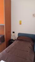 A bed or beds in a room at Pitagora