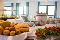 a table with some bread and flowers on it at Mediterranean Beach Resort in Laganas