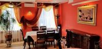 a dining room with red walls and a table and chairs at Едем in Skhidnitsa