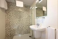 a bathroom with a sink and a shower with a mirror at Hotel Tugasa Arco de la Villa in Zahara de la Sierra