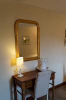 a mirror on a desk with a lamp and a chair at Château de Ribourdin in Chevannes