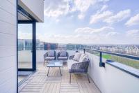 a balcony with couches and a table on a building at Grand appartement avec belle vue Paris in Rueil-Malmaison