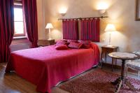 a bedroom with a red bed with red curtains at Château de Ribourdin in Chevannes