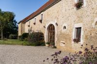 a stone building with a door and flowers on it at Château de Ribourdin in Chevannes