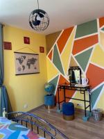 a bedroom with a colorful wall with a bed at Le Moulin du Modon in Couffy