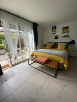 a bedroom with a bed and a large window at COSY ROOM PRIVATE BATH AND GARDEN in Anglet