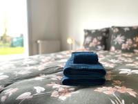 a pile of blue towels sitting on top of a bed at La belle des champs in Luzillé