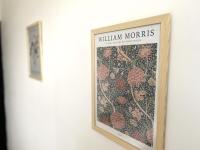 a picture of a poster of william morris on a wall at La belle des champs in Luzillé