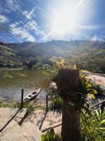 a view of a body of water with a boat at Hotel Fazenda Upã Moña in Vassouras
