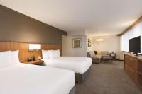 a hotel room with two beds and a couch at Hyatt Place Chicago O'Hare Airport in Rosemont