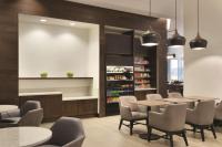 a restaurant with tables and chairs and a liquoracist at Hyatt Place Chicago O'Hare Airport in Rosemont