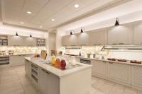 a large kitchen with white cabinets and a large island at Hyatt Place Chicago O'Hare Airport in Rosemont