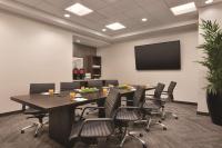 a conference room with a table and chairs and a tv at Hyatt Place Chicago O'Hare Airport in Rosemont