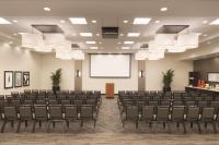 a conference room with chairs and a screen at Hyatt Place Chicago O'Hare Airport in Rosemont