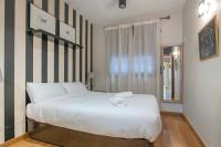Postel nebo postele na pokoji v ubytování Modern and bright apartment in Eixample 2-2