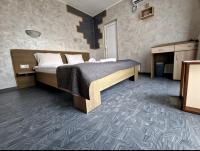 A bed or beds in a room at Guest House Simon Green