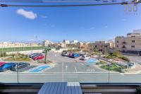 a view from a window of a parking lot at Bright &amp; cosy 3BR home with private balcony &amp; WIFI by 360 Estates in Dingli