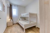 a bedroom with two bunk beds in a room at Bright &amp; cosy 3BR home with private balcony &amp; WIFI by 360 Estates in Dingli
