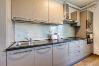 a kitchen with white cabinets and a sink at Bright &amp; cosy 3BR home with private balcony &amp; WIFI by 360 Estates in Dingli