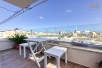 a table and two chairs on a balcony with a view at Bright &amp; cosy 3BR home with private balcony &amp; WIFI by 360 Estates in Dingli