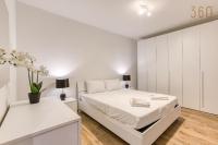a white bedroom with a white bed and white cabinets at Bright &amp; cosy 3BR home with private balcony &amp; WIFI by 360 Estates in Dingli